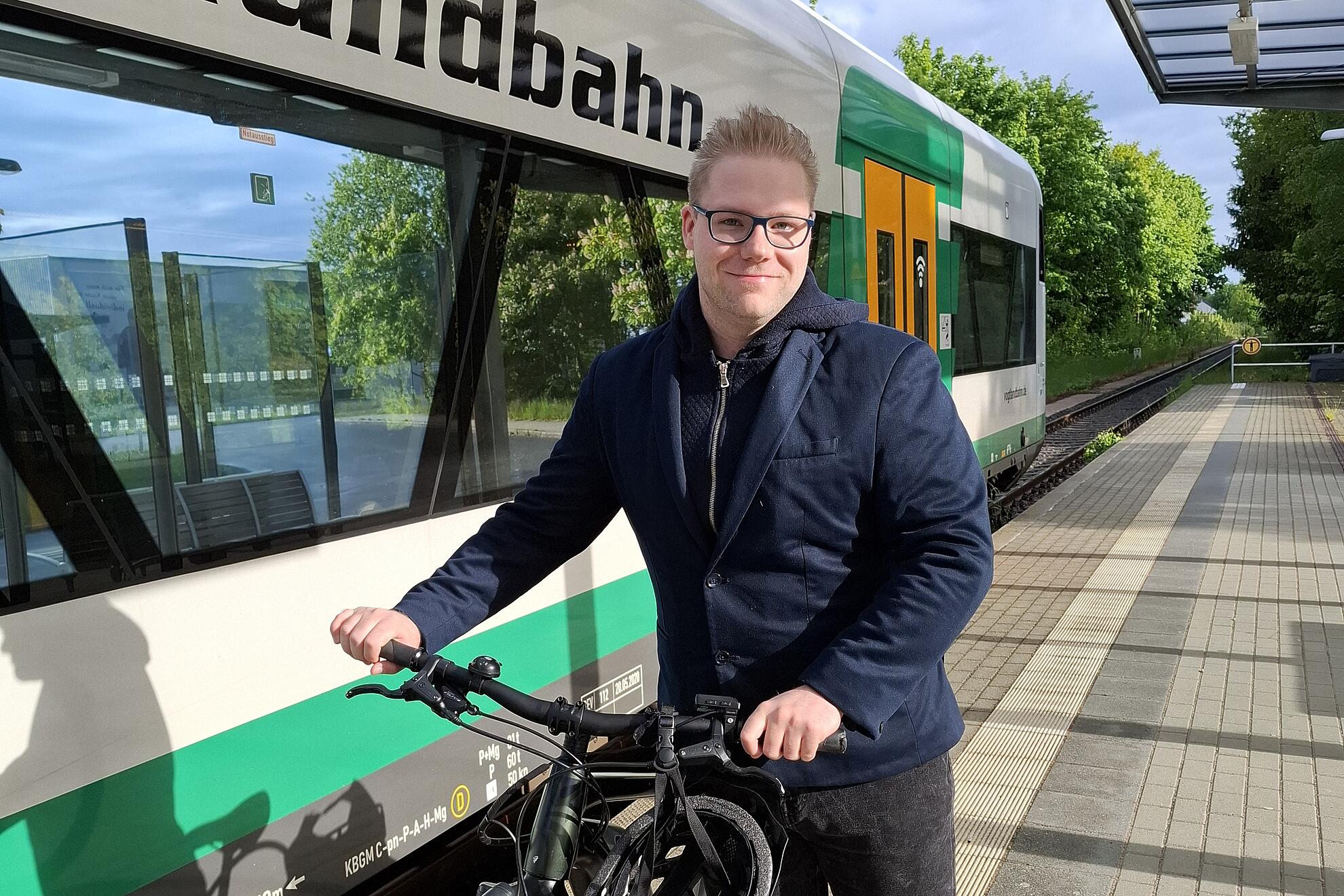 Verkehrsplaner Alexander Herzog steht mit seinem Fahrrad am Bahnsteig